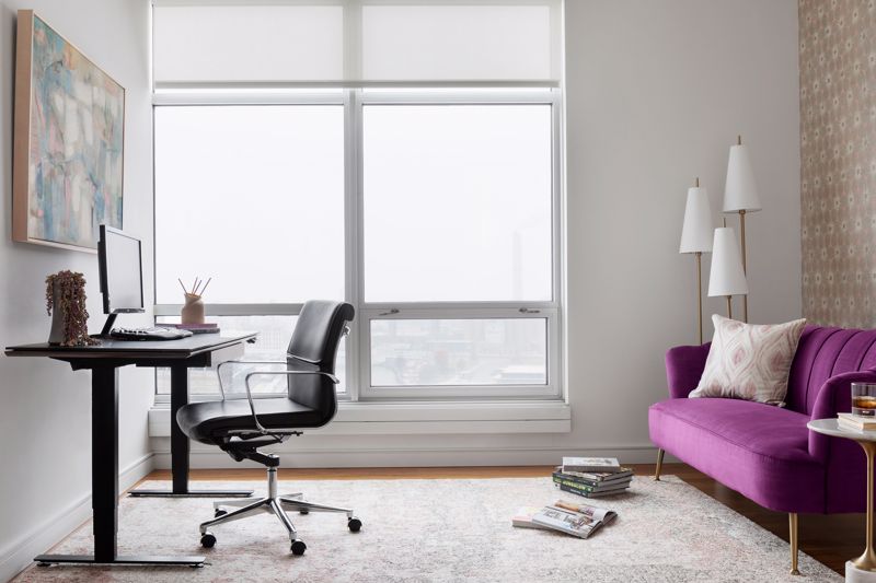 Minimalist home office with purple sofa